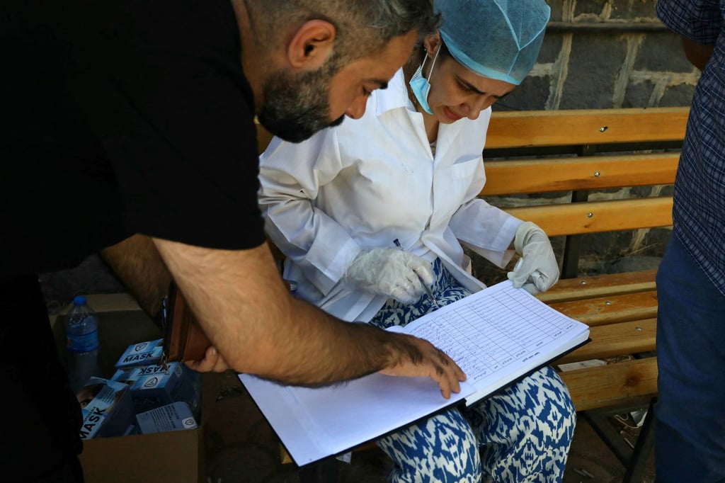 A health worker fills out a list of victims of the recent clashes. Photo: AFP A health worker fills out a list of victims of the recent clashes. Photo: AFP