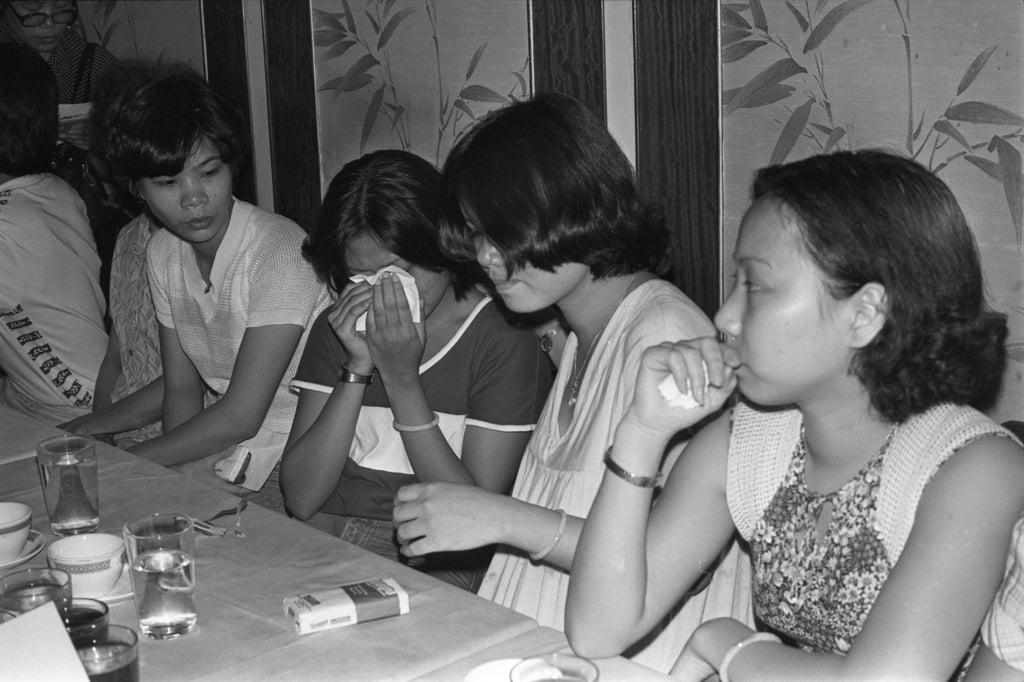 A friend comforts Fok Mei-po, who broke down and wept at a press conference as one of her sisters was killed and another was put in hospital following the North Point bus accident. Photo: SCMP Archives