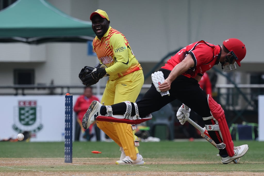 Anshuman Rath (right) makes his ground amid a run-out appeal from Uganda wicketkeeper Fred Achelam. Photo: Dickson Lee
