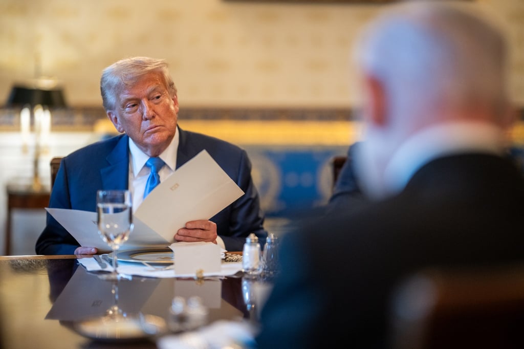US President Donald Trump holds a copy of a letter from Israeli Prime Minister Benjamin Netanyahu (foreground) to the Nobel Committee nominating Trump for the Peace Prize, at the White House on July 7. Photo: dpa