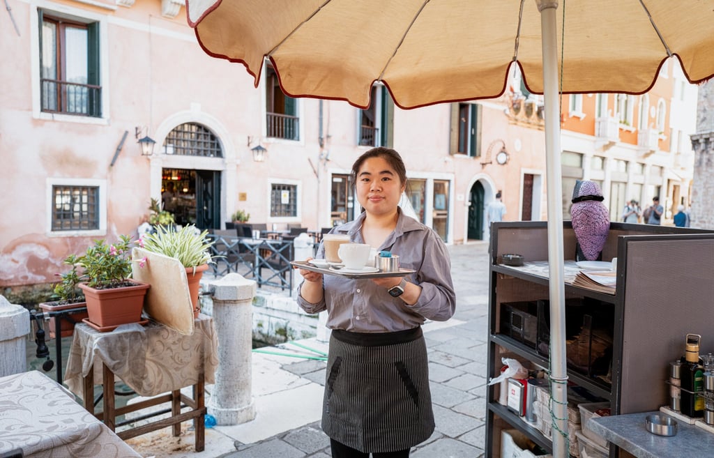 Barista Sophia serves coffee on the terrace of Bar Foscarini, which sits beside the Grand Canal in Venice. Photo: Federico Sutera Barista Sophia serves coffee on the terrace of Bar Foscarini, which sits beside the Grand Canal in Venice. Photo: Federico Sutera