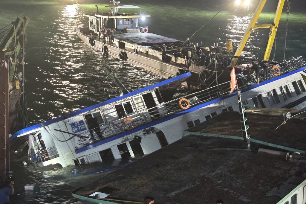 A tourist boat is being salvaged in Ha Long Bay, Vietnam on Sunday. Photo: EPA/VNA