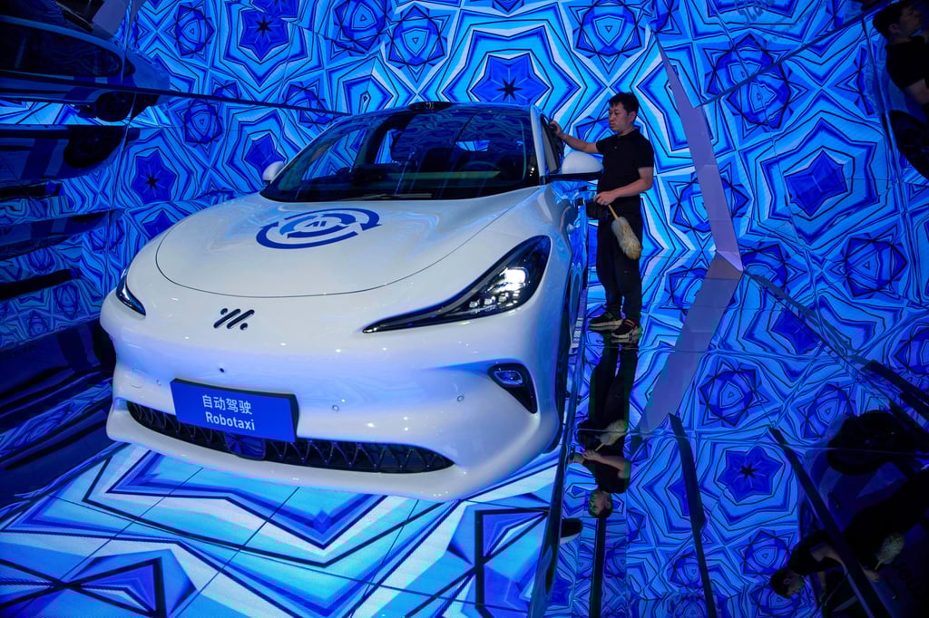 A worker cleans a robotaxi in Shanghai. Photo: AP A worker cleans a robotaxi in Shanghai. Photo: AP