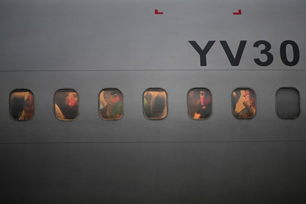 Migrants who were jailed in El Salvador returning to Venezuela. Photo: AFP