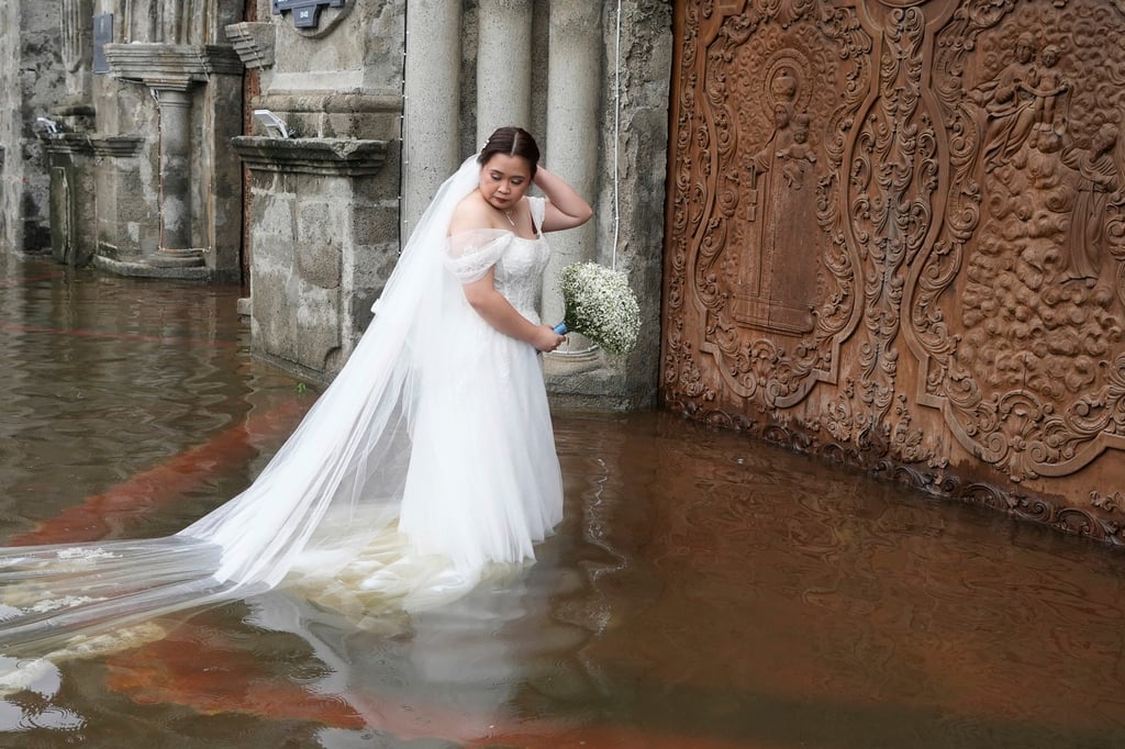 Bride Jamaica Agular prepares to enter a flooded Barasoain church for her wedding on Tuesday. Photo: AP