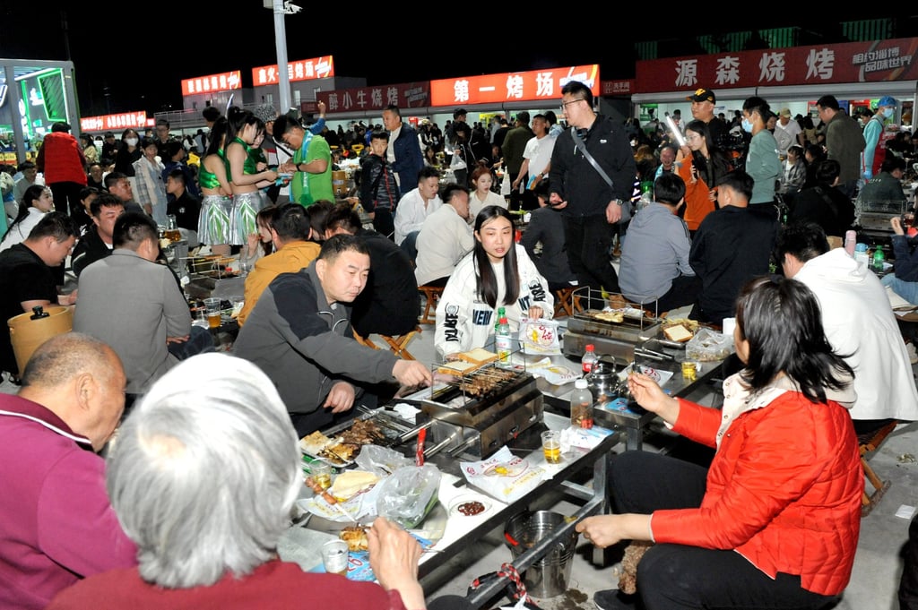 Tourists enjoy a barbecue feast at a gourmet marketplace. Skewered meat dining is hugely popular in China. Photo: Getty Images Tourists enjoy a barbecue feast at a gourmet marketplace. Skewered meat dining is hugely popular in China. Photo: Getty Images