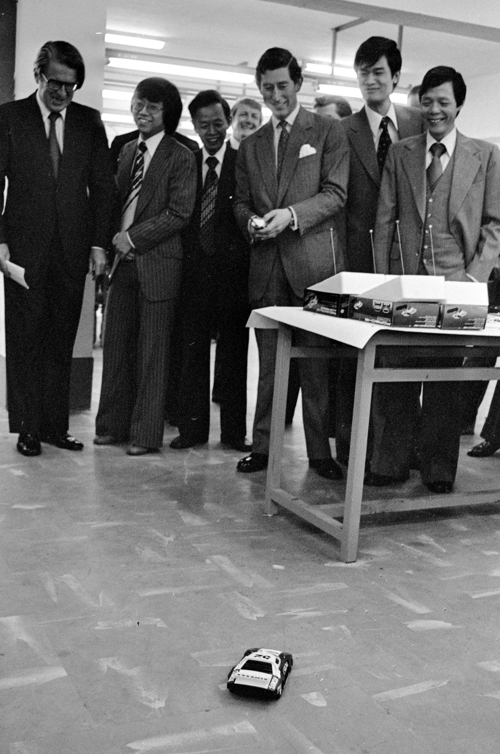Prince Charles (third right) tries a remote-controlled toy car at Sun Chung Precision Metal Factory in San Po Kong in 1979. Photo: SCMP Archives