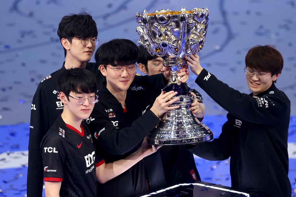 Members of the Edward Gaming esports team from Shanghai hoist the Summoner’s Cup after winning the 2021 League of Legends World Championship in Reykjavik, Iceland. Photo: Riot Games via Getty Images