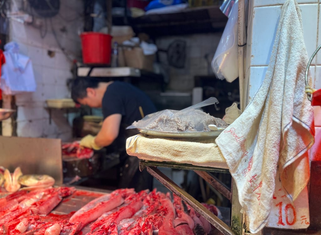 A Good Morning towel is seen hanging at a fishmonger’s stall at a wet market in Causeway Bay. Photo: Kylie Knott