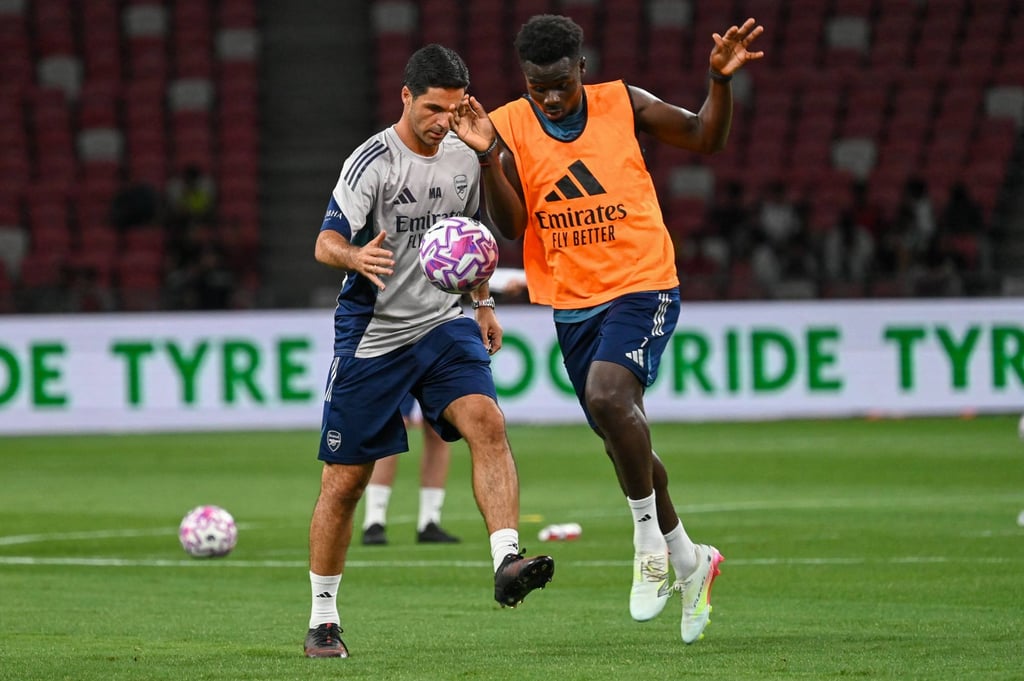 Arsenal manager Mikel Arteta (left) and Bukayo Saka during a pre-season training session at the National Stadium in Singapore. Photo: AFP