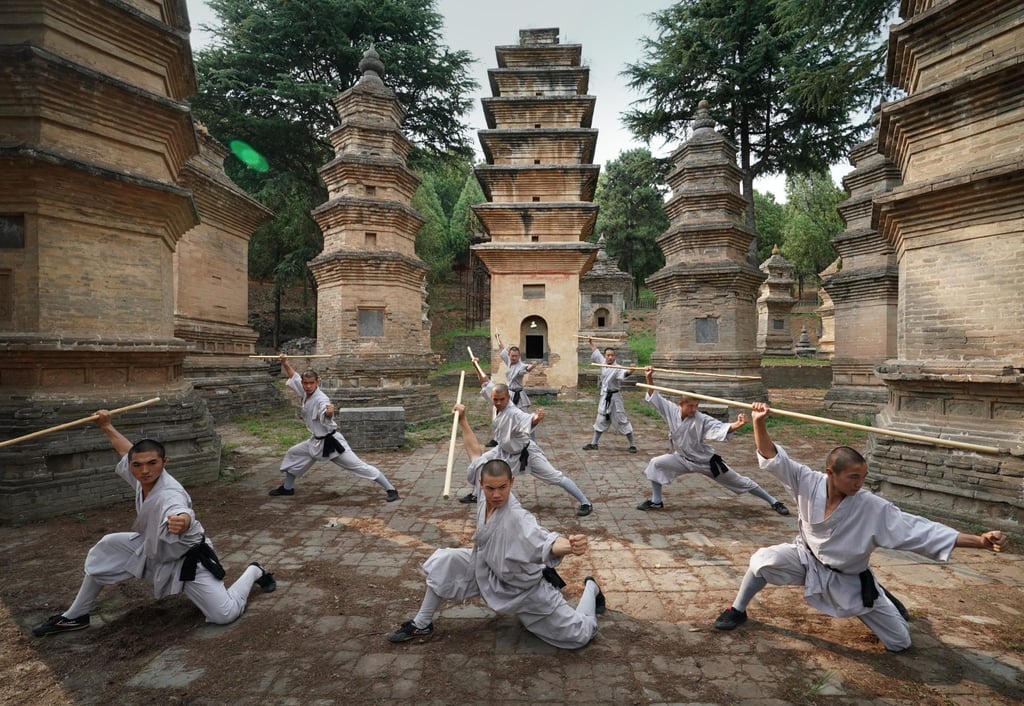 Shaolin monks practise martial arts at the temple’s Pagoda Forest. Photo: Xinhua Shaolin monks practise martial arts at the temple’s Pagoda Forest. Photo: Xinhua