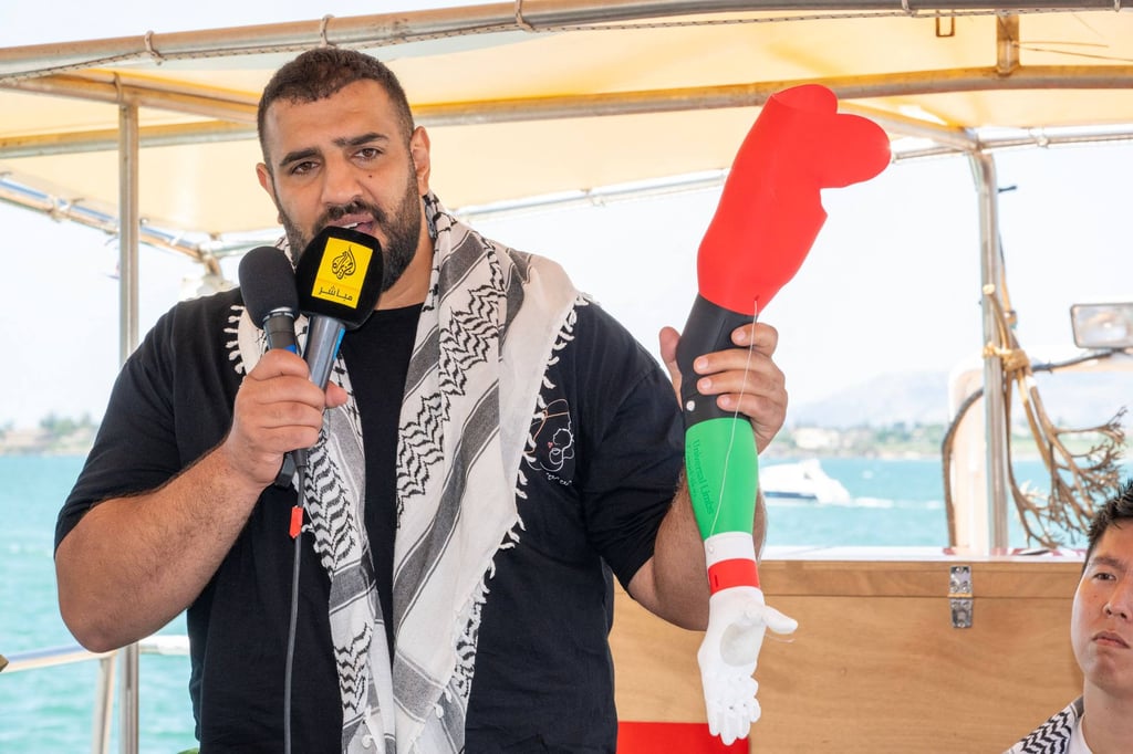 Australian doctor Mohamed Mustafa addresses a press conference holding a prosthesis on the Freedom Flotilla ship Handala, ahead of the boat’s departure for Gaza at a port in Syracuse, Sicily, southern Italy, on July 13, 2025. Photo: AFP Australian doctor Mohamed Mustafa addresses a press conference holding a prosthesis on the Freedom Flotilla ship Handala, ahead of the boat’s departure for Gaza at a port in Syracuse, Sicily, southern Italy, on July 13, 2025. Photo: AFP