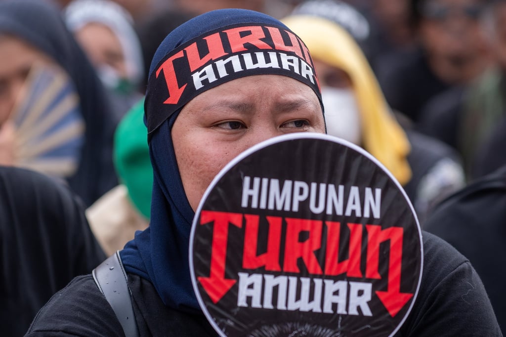 A protester holds a sign calling for Anwar to resign during a rally in Kuala Lumpur on Saturday. Photo: EPA A protester holds a sign calling for Anwar to resign during a rally in Kuala Lumpur on Saturday. Photo: EPA