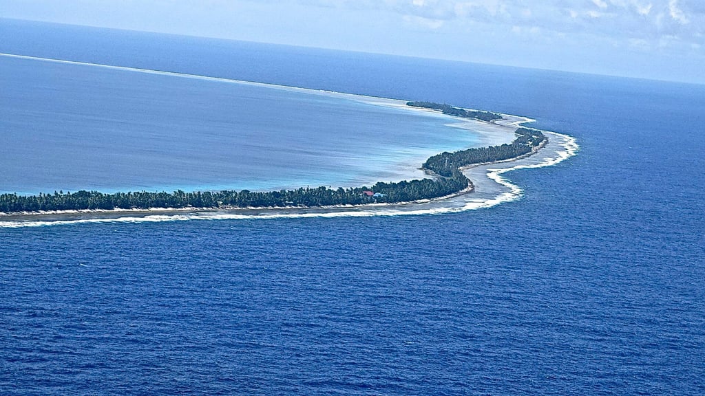 Rising sea levels threaten to cut off a road that runs along an atoll in Tuvalu. Photo: Kalinga Seneviratne
