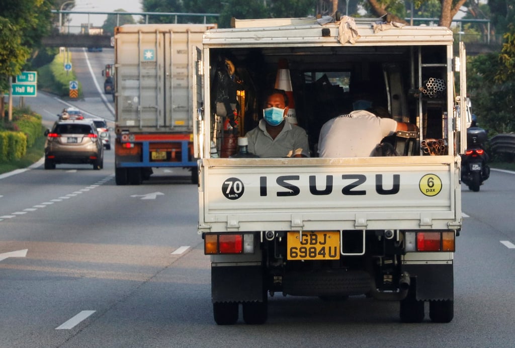 Migrant workers are transported in the back of a lorry in Singapore in 2020. Photo: Reuters Migrant workers are transported in the back of a lorry in Singapore in 2020. Photo: Reuters