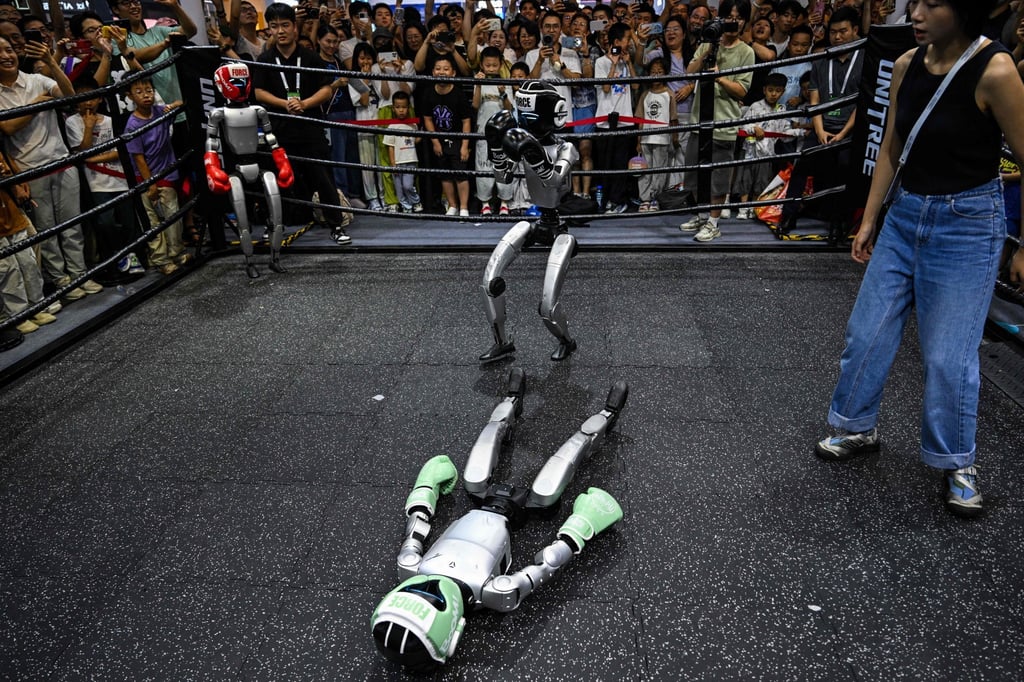 A remote-controlled robot by Unitree Robotics lies on the ground in a boxing match during the World Artificial Intelligence Conference on Monday. Photo: AFP A remote-controlled robot by Unitree Robotics lies on the ground in a boxing match during the World Artificial Intelligence Conference on Monday. Photo: AFP