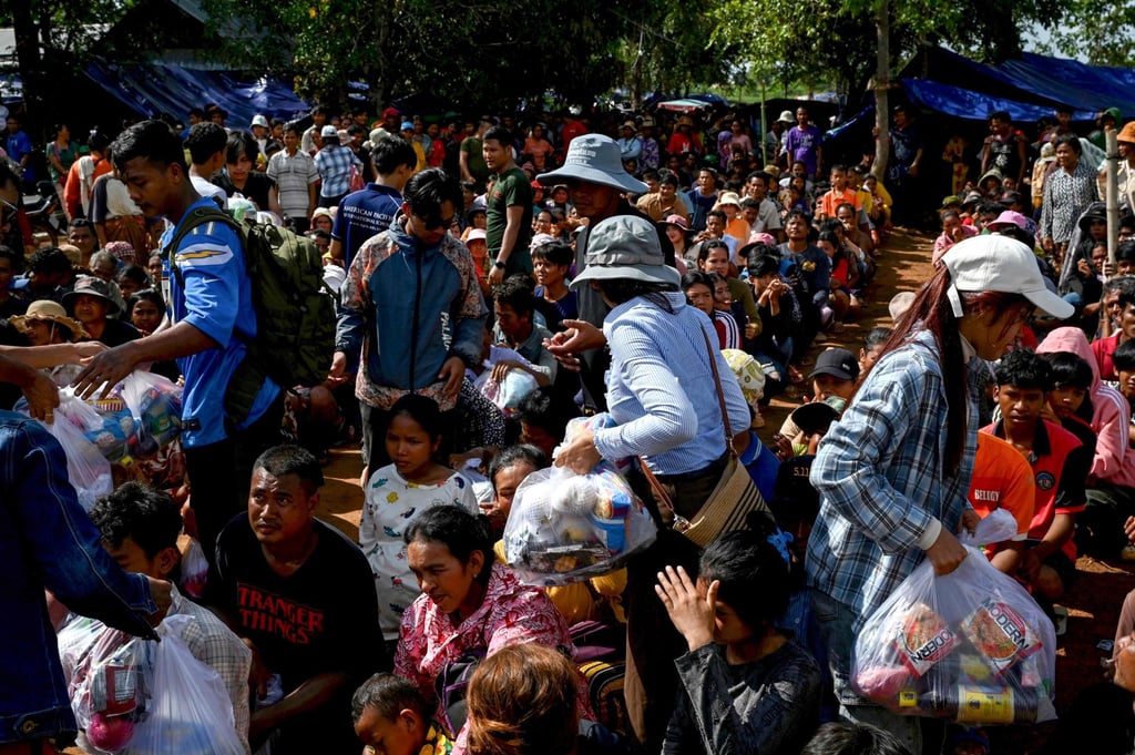 People who fled their homes near the border between Cambodia and Thailand gather at a food distribution site on the grounds of a pagoda in Oddar Meanchey province on Monday. Both countries have agreed to a ceasefire. Photo: AFP People who fled their homes near the border between Cambodia and Thailand gather at a food distribution site on the grounds of a pagoda in Oddar Meanchey province on Monday. Both countries have agreed to a ceasefire. Photo: AFP