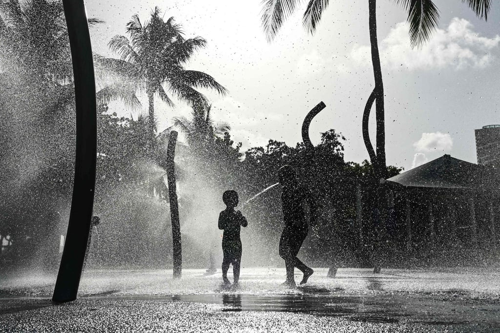 Children play on the splash pad as the region is under an extreme heat warning in Miami Beach, Florida, on Friday. Photo: AFP