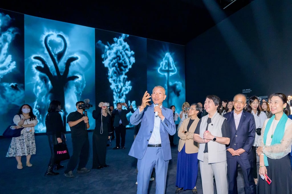 Cai (centre) gives a tour of his new exhibition in Macau during its opening ceremony. Cai (centre) gives a tour of his new exhibition in Macau during its opening ceremony.