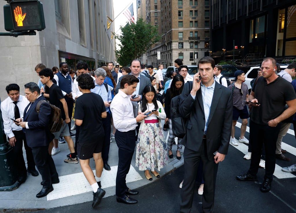 People gather outside as police respond to a nearby shooting incident in the Midtown Manhattan neighbourhood of New York on Monday. Photo: AFP