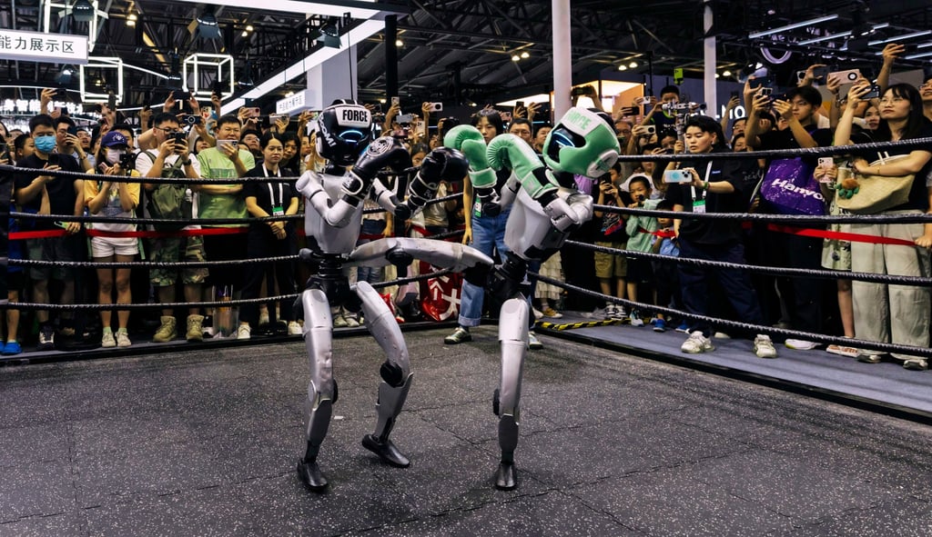 Visitors outside a ring watch a pair of remote-controlled G1 humanoid robots from Unitree Robotics engage in a kickboxing match at the World Artificial Intelligence Conference in Shanghai on Monday. Photo: EPA Visitors outside a ring watch a pair of remote-controlled G1 humanoid robots from Unitree Robotics engage in a kickboxing match at the World Artificial Intelligence Conference in Shanghai on Monday. Photo: EPA