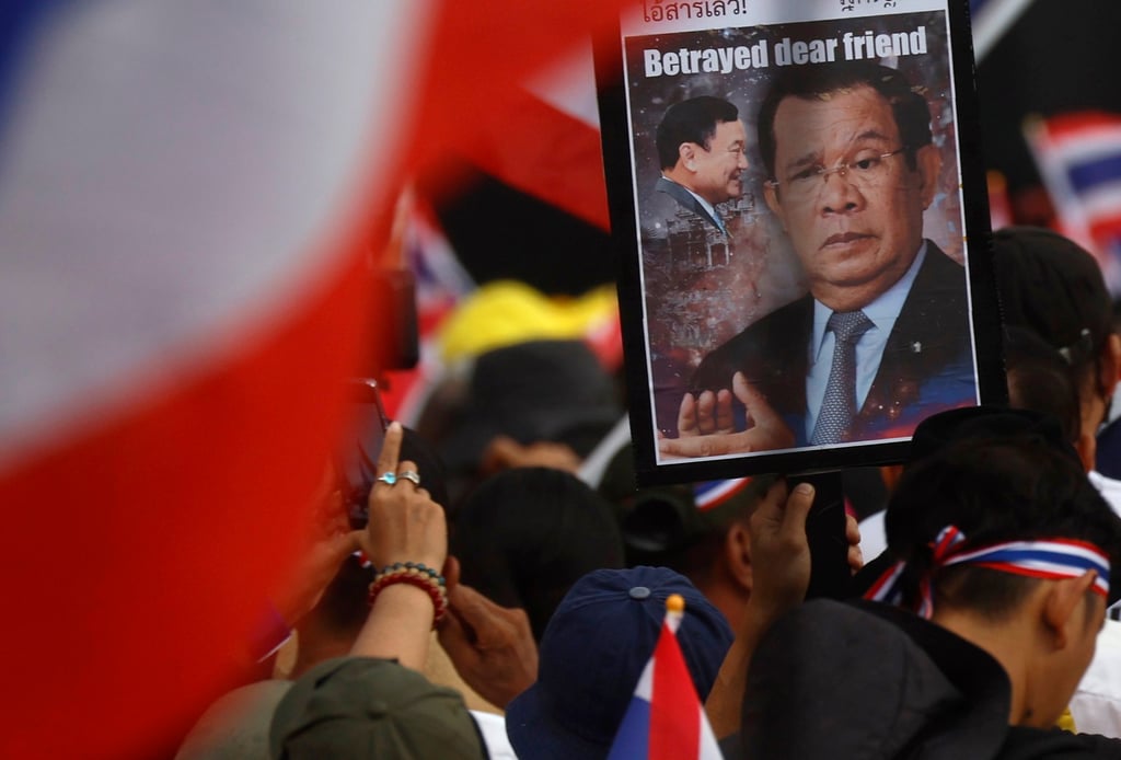 A demonstrator holds a placard depicting former Cambodian leader Hun Sen (right) and former Thai prime minister Thaksin Shinawatra during a rally in Bangkok last month before the outbreak of hostilities. Photo: EPA