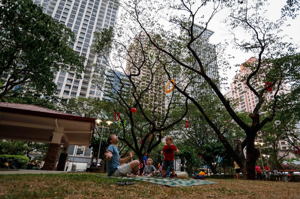 A family plays with a ball at a pocket park on private land in Makati, south of Manila, in 2019. Marcos urged local governments to revitalise public parks and plazas. Photo: EPA-EFE A family plays with a ball at a pocket park on private land in Makati, south of Manila, in 2019. Marcos urged local governments to revitalise public parks and plazas. Photo: EPA-EFE