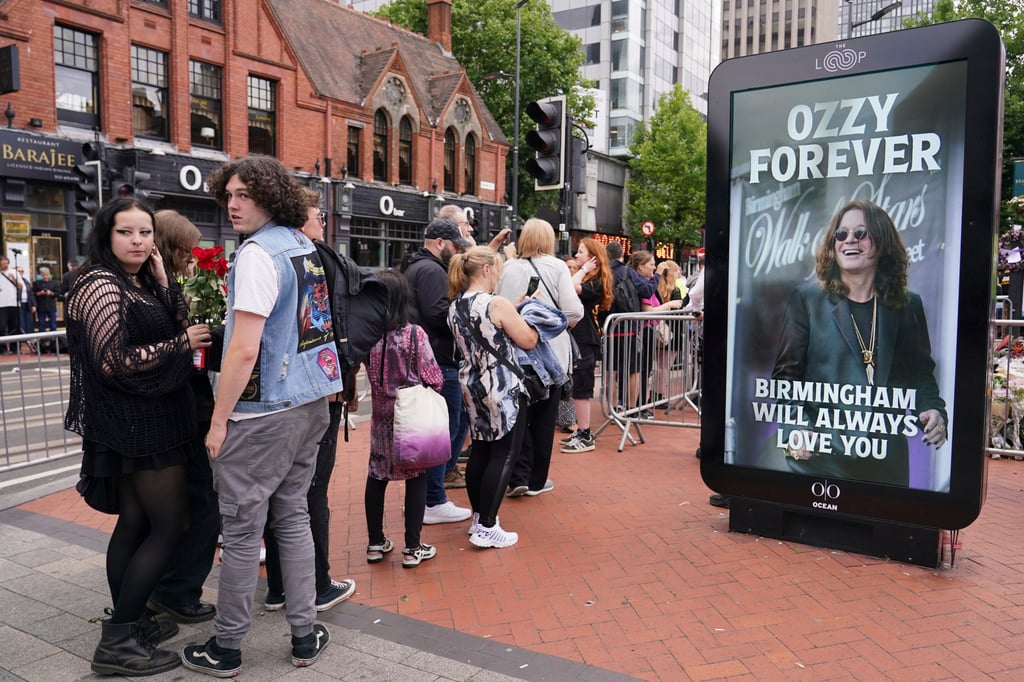 Fans queue to view and leave tributes to musician Osbourne in Birmingham, England on Wednesday. Photo: AP