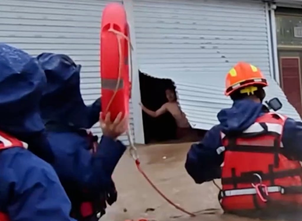 The husband can be seen looking out of his eatery as floodwaters rage around it and firefighters prepare to save him and his wife. Photo: Handout The husband can be seen looking out of his eatery as floodwaters rage around it and firefighters prepare to save him and his wife. Photo: Handout