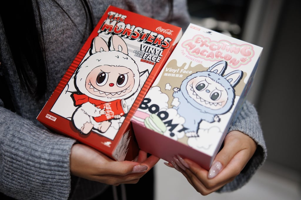 A customer holds boxes with Labubu figures in the first Pop Mart store selling Labubu toys in Berlin, Germany, on July 25. Photo: EPA