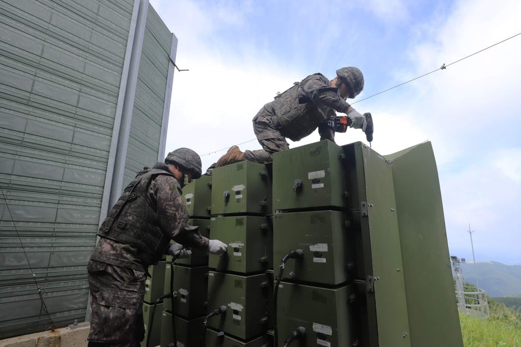 Soldiers dismantle propaganda loudspeakers aimed at North Korea on Monday. Photo: South Korean Defence Ministry Soldiers dismantle propaganda loudspeakers aimed at North Korea on Monday. Photo: South Korean Defence Ministry