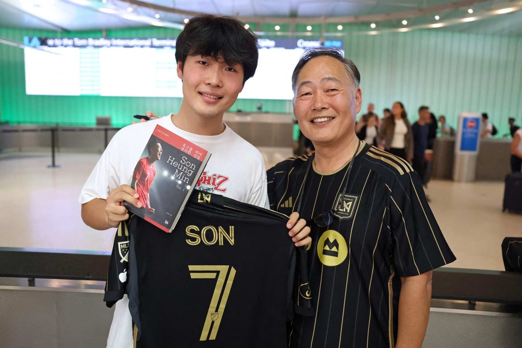 Jun Kwon (left) and his father Hojin pose with their LAFC shirts at Los Angeles airport. Photo: AFP