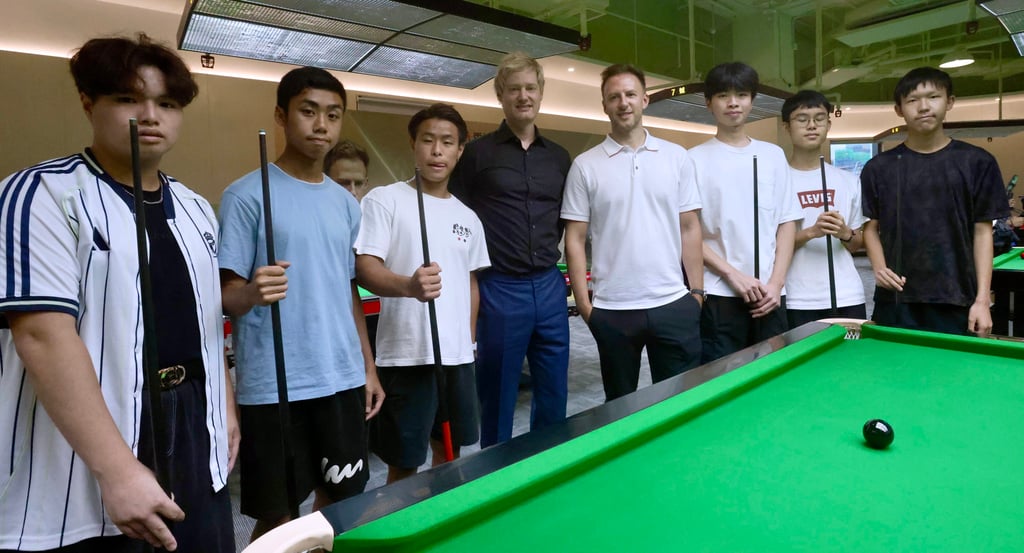 Neil Robertson and Judd Trump (left and right in the middle) with young players at the academy. Photo: Jonathan Wong Neil Robertson and Judd Trump (left and right in the middle) with young players at the academy. Photo: Jonathan Wong