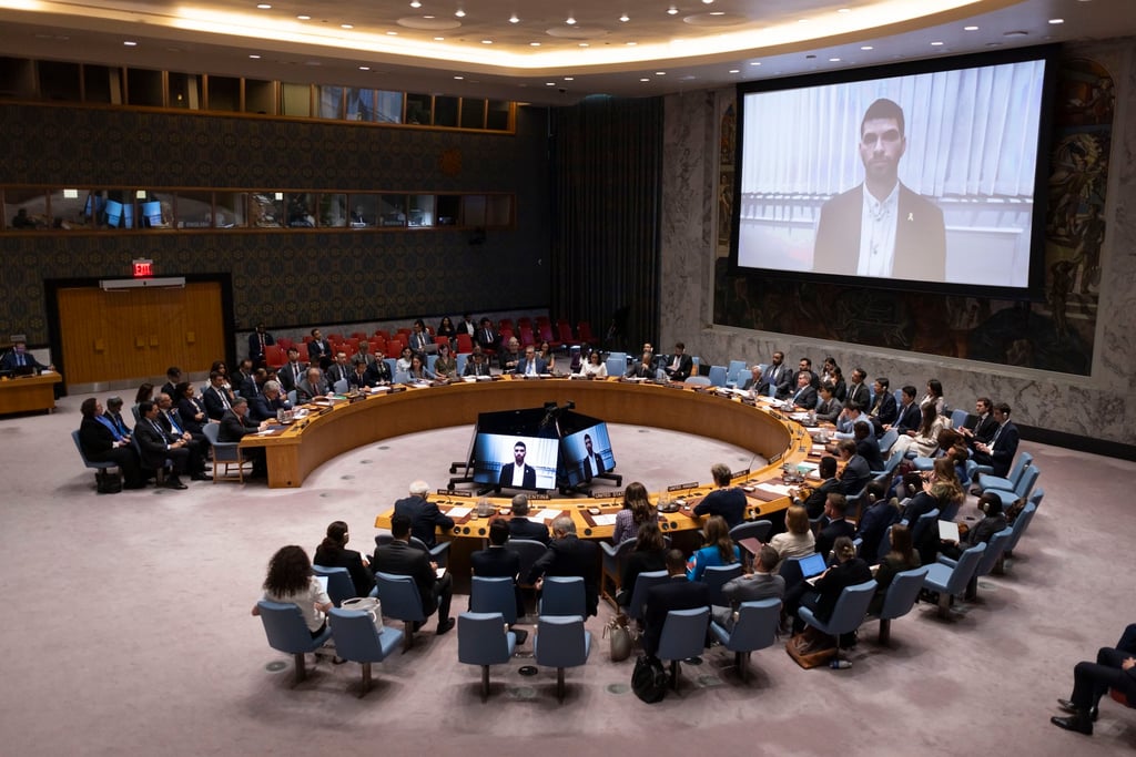 Ilay David, on screen, speaks about his brother Evyatar, who is being held hostage in Gaza. Photo: EPA Ilay David, on screen, speaks about his brother Evyatar, who is being held hostage in Gaza. Photo: EPA