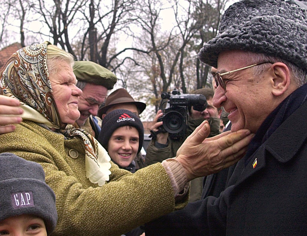 An elderly Romanian woman reaches out to President Ion Iliescu at the end of celebrations for Romania’s national day in Bucharest in December 2001. File photo: AP