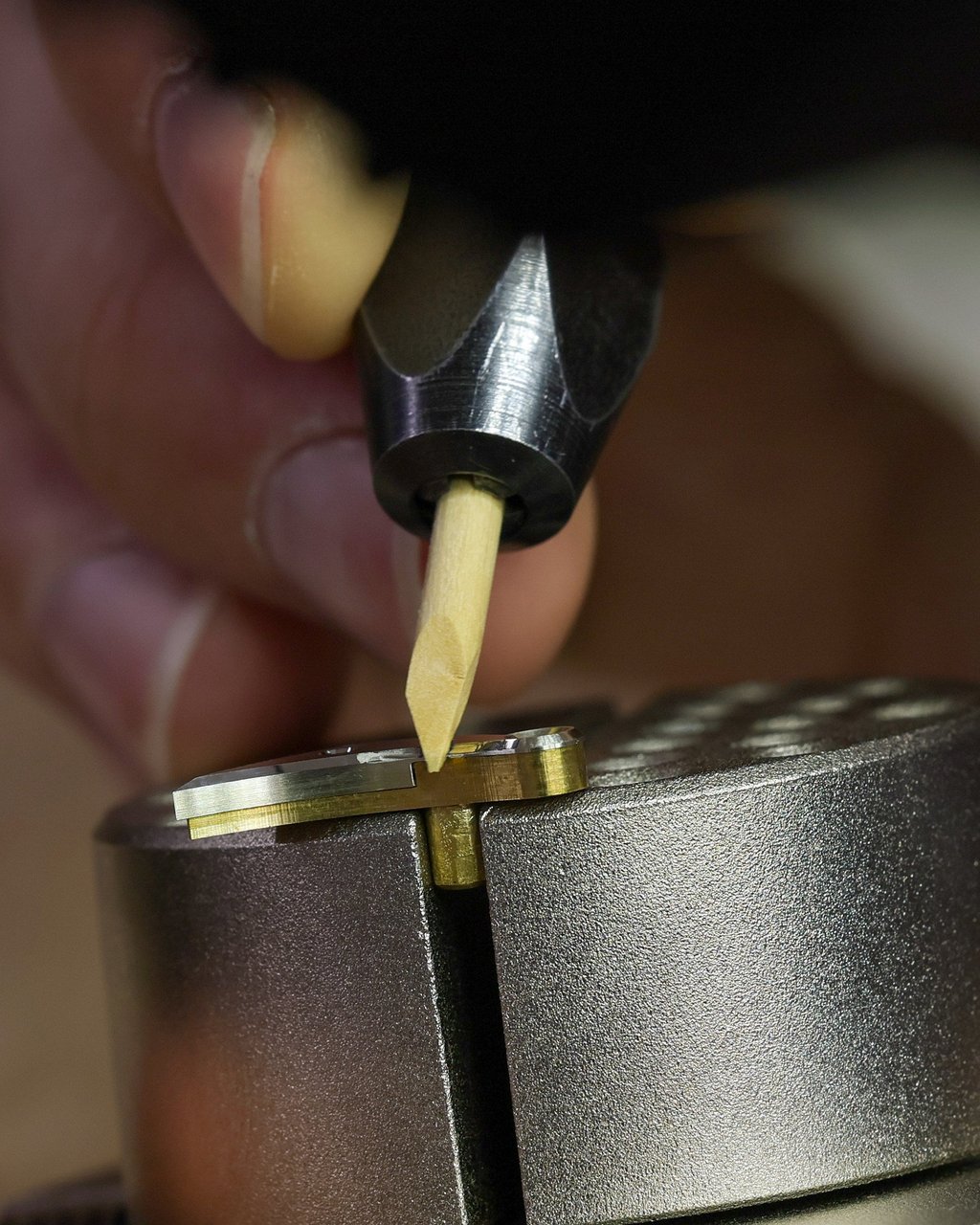 Spencer Torok, a watchmaker at JN Shapiro Watches in California, polishes a component of a Resurgence series watch. Photo: TNS