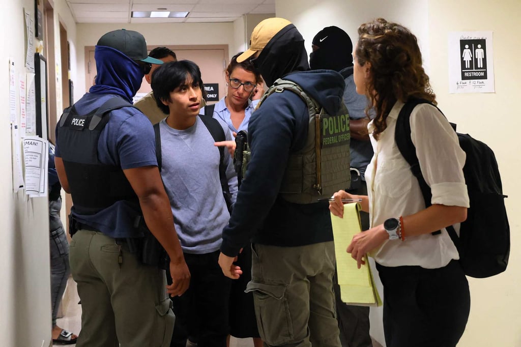 Federal agents detain a person exiting an immigration court hearing in New York City on August 6. Photo: Getty Images/AFP