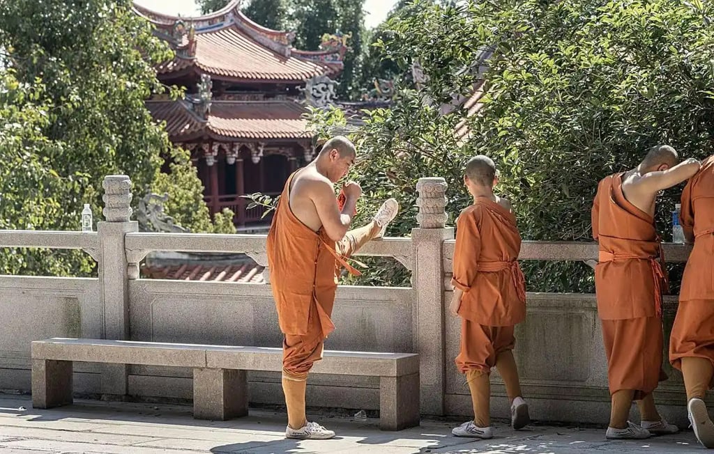 A monk stretches to get himself ready for the strict new way of life at the Shaolin Temple. Photo: Baidu