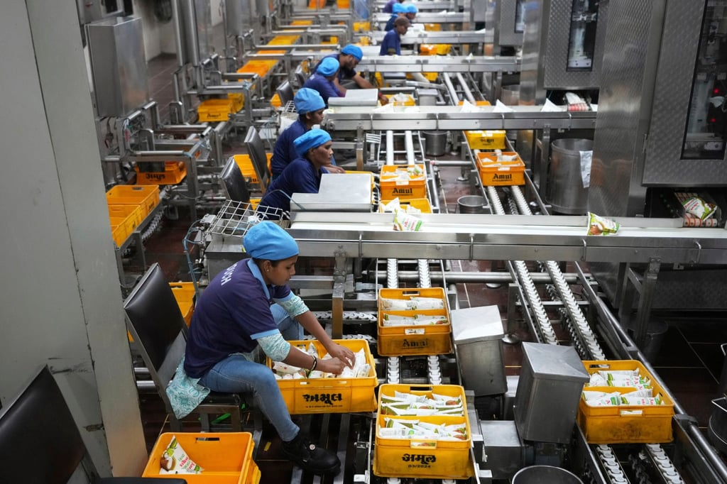 Employees work at a buttermilk packaging plant in Gandhinagar, India, on August 7. US President Donald Trump has abruptly doubled tariffs on Indian goods. Photo: AP