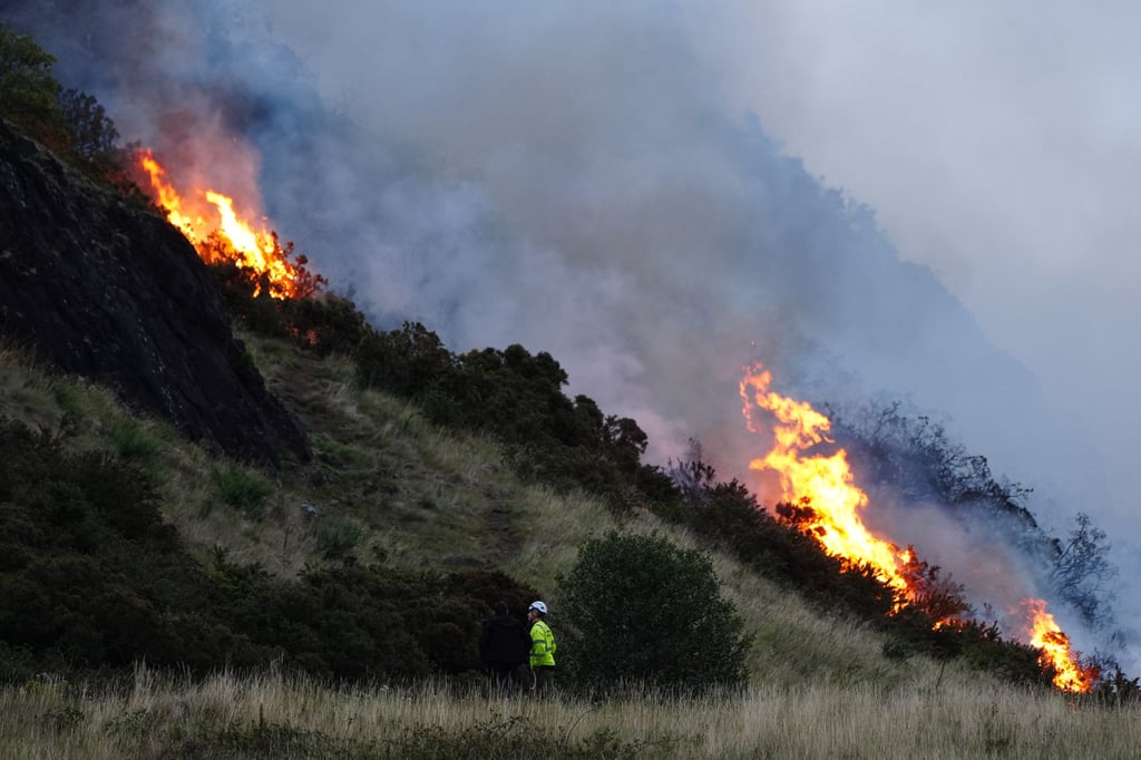 Flames and smoke rise from a fire on Arthur’s Seat. Photo: PA Wire via dpa