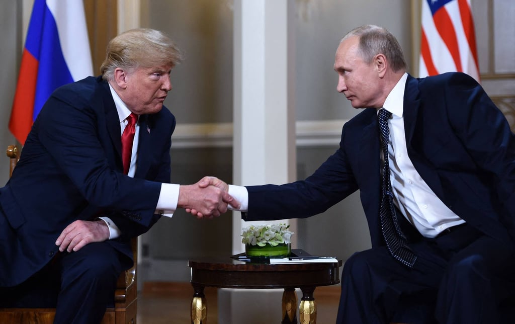 US President Donald Trump and Russian President Vladimir Putin shake hands before a meeting in Helsinki in July 2018. Photo: AFP US President Donald Trump and Russian President Vladimir Putin shake hands before a meeting in Helsinki in July 2018. Photo: AFP