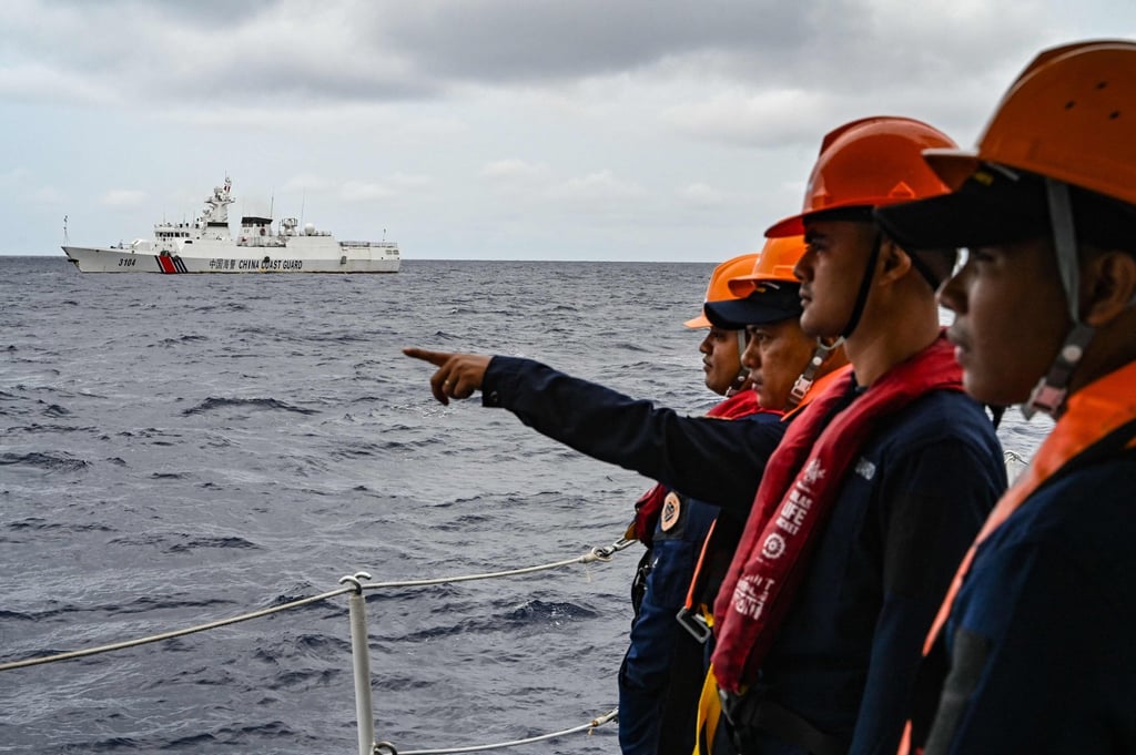 Members of the Philippine coastguard monitor a Chinese coastguard in disputed waters of the South China Sea last year. Photo: AFP