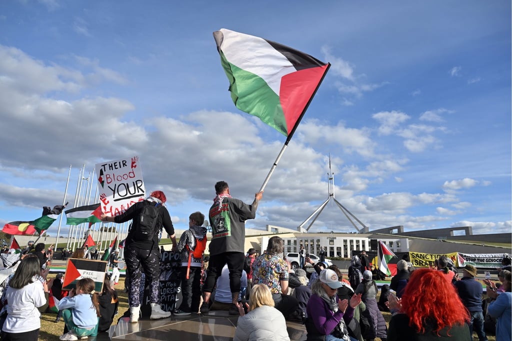 Protesters wave Palestinian flags at a rally outside Parliament House in Canberra last month, calling for sanctions against Israel. Photo: EPA Protesters wave Palestinian flags at a rally outside Parliament House in Canberra last month, calling for sanctions against Israel. Photo: EPA