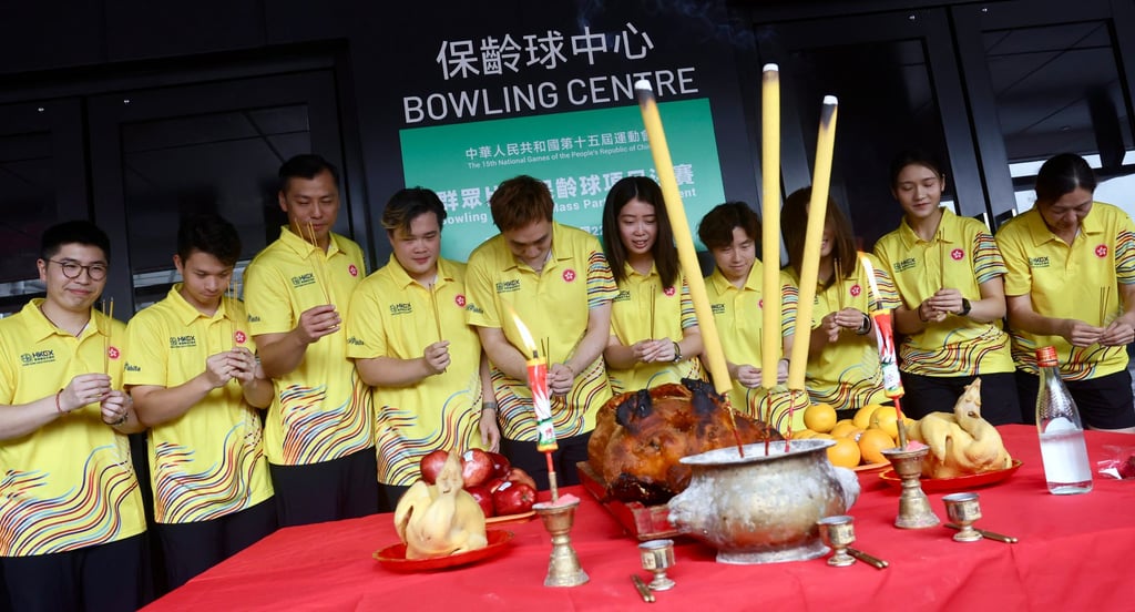 Hong Kong’s bowling team at a roast pig cutting ceremony at Top Bowl in Kai Tak. Photo: Jonathan Wong