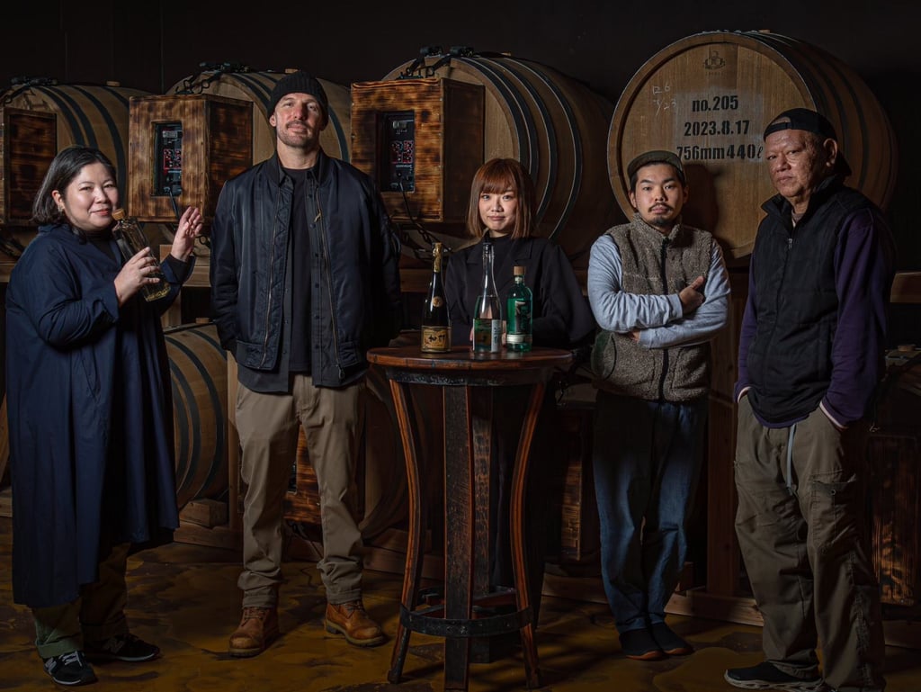Selena Nishihira (centre), president of Nishihira Distillery, poses with colleagues at the distillery. Photo: X/kana_sango