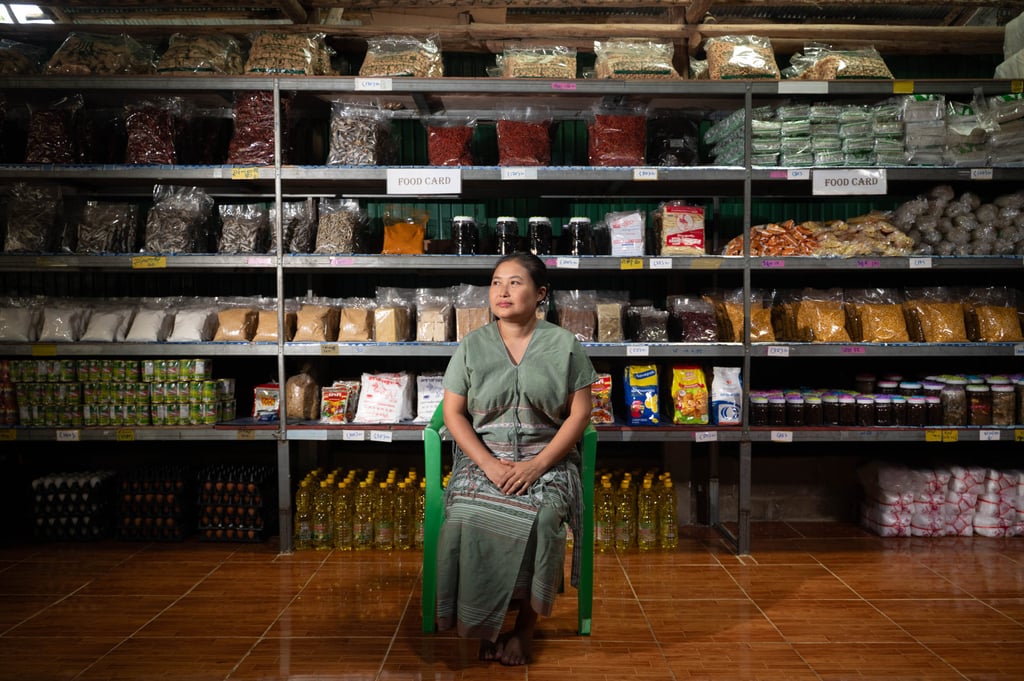 Naw Wah Nay Paw, 40, sits before shelves of food at her shop in Mae La Camp on July 31. Photo: Janelle Ling Naw Wah Nay Paw, 40, sits before shelves of food at her shop in Mae La Camp on July 31. Photo: Janelle Ling