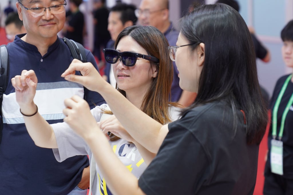 Visitors try on smart glasses during the third China International Supply Chain Expo in Beijing last month. Photo: Xinhua Visitors try on smart glasses during the third China International Supply Chain Expo in Beijing last month. Photo: Xinhua