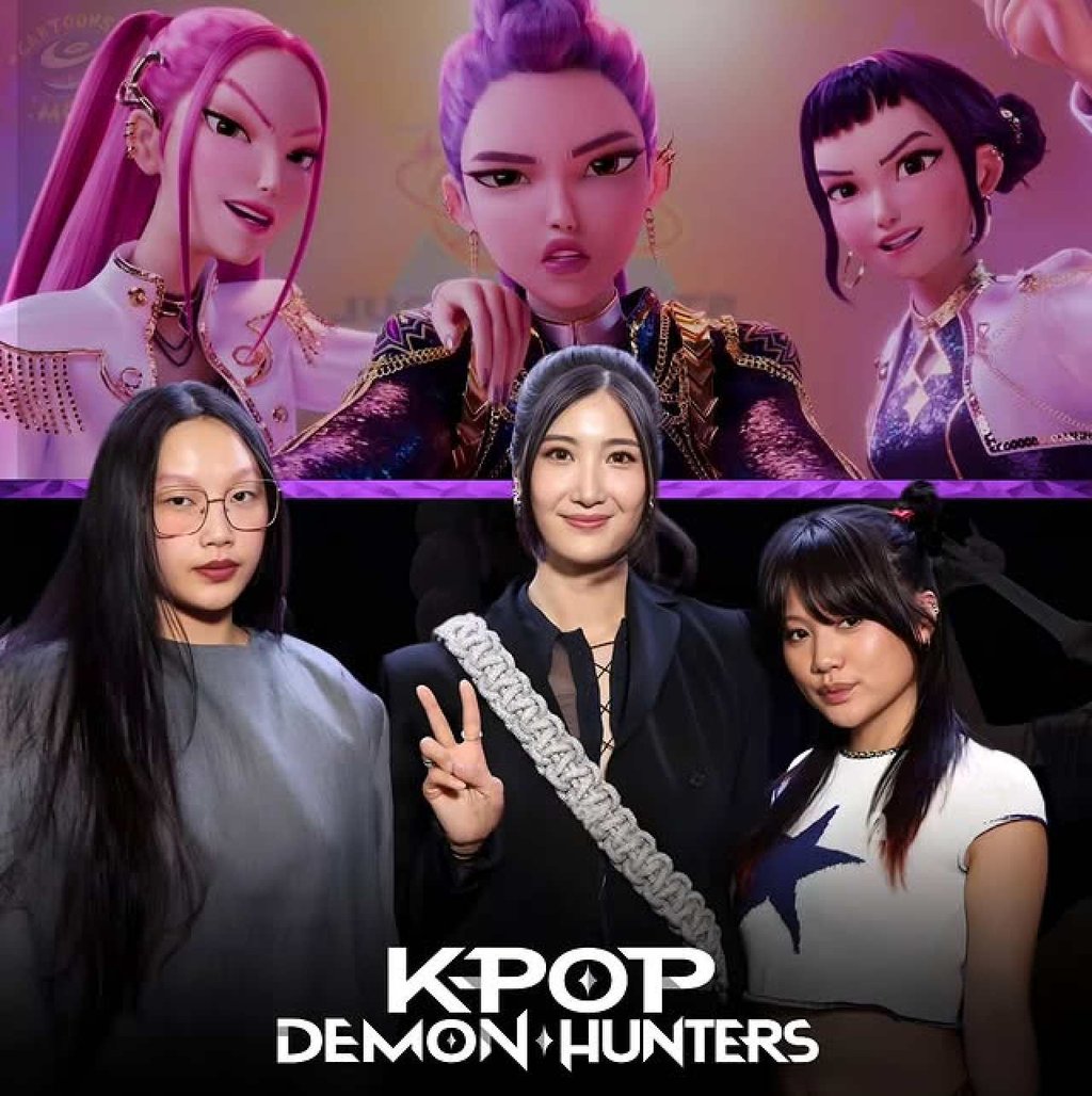 Audrey Nuna, Ejae and Rei Ami pose with a poster of their animated Netflix film Kpop Demon Hunters. Photo: @cartoonsonthemoon/Instagram