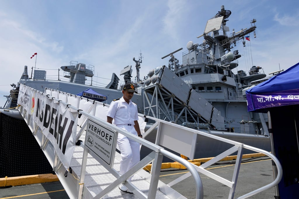 A crew member disembarks from the Indian guided-missile destroyer INS Delhi after it docked in Manila on August 1. Photo: AP
