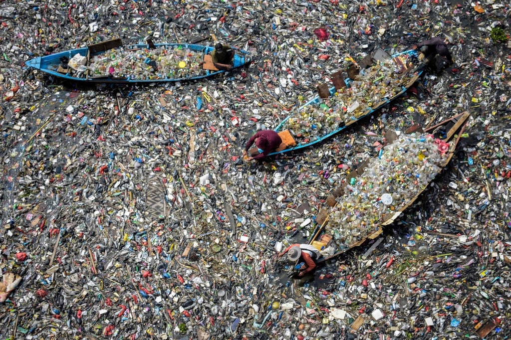 People in boats collect plastic waste from a heavily polluted river in Bandung, Indonesia, last year. Malaysia is one of Southeast Asia’s largest plastic producers. Photo: AFP